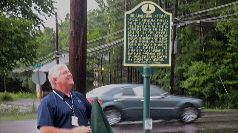 Monroe County Commissioner John Christy unveils the marker.