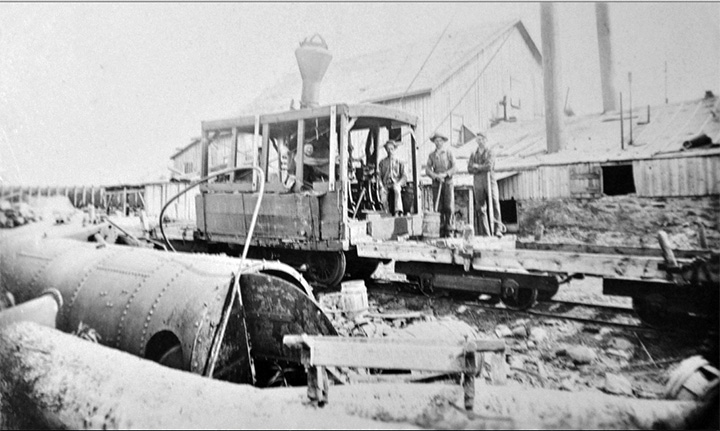 Early locomotive loads lumber at Stauffer’s Mill.