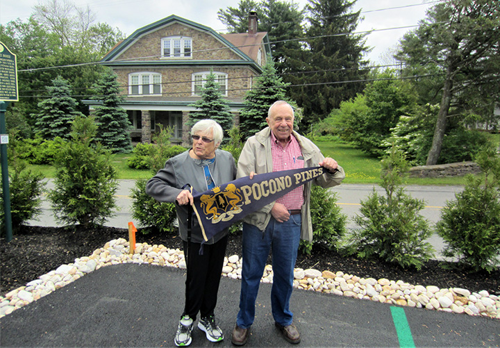 Jean Van Gilder and Joe Miller with a vintage Pocono Pines pennant.